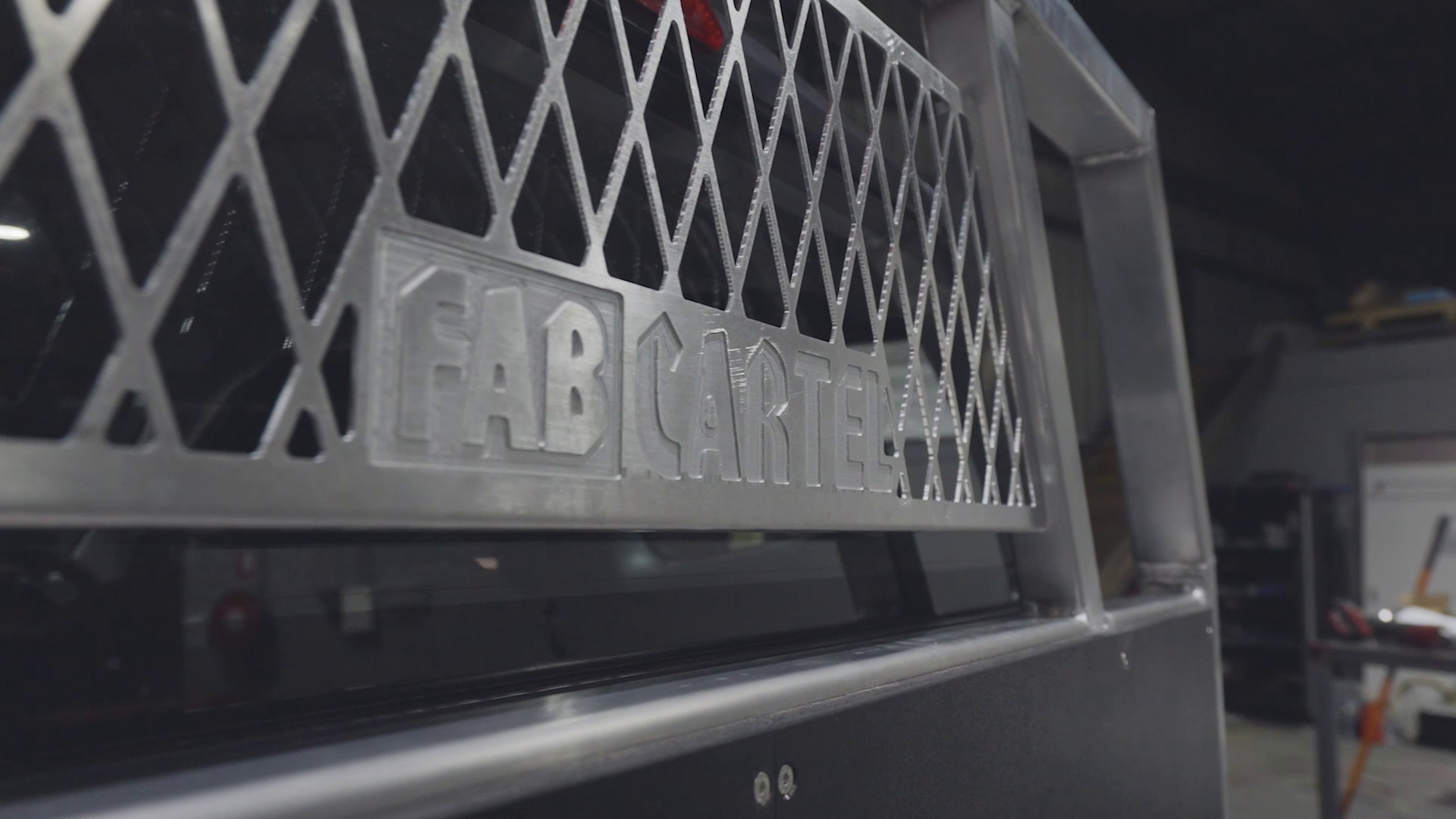 CNC cut FAB CARTEL logo in an aluminium headboard mesh